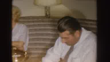 Nebraska (1955): Man And Woman Sit On Couch In Living Room Man Sips Drink From