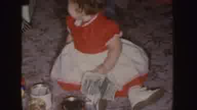 Nebraska (1955): Child Playing On The Ground With Toys Wearing Old Limey Dress
