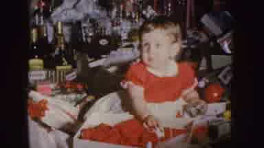 Nebraska (1955): Blonde Girl In Red Dress Sitting And Playing With A Toy