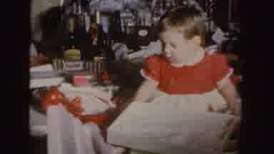 Nebraska (1955): Girl Wearing Red And White Dress Looks At Empty Gift Box Near