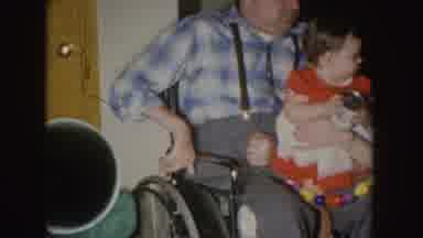 Nebraska (1955): Little Girl Holding A Can As A Toy In The Lap Of A Man On A