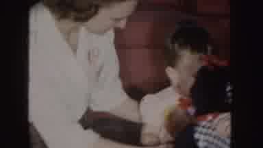 Nebraska (1955): Mother Plays With Children And Teddy Bear In A Moment Of Fun