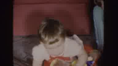 Nebraska (1955): A Toddler Dressed In Red And White With Dirty Blonde Hair Moves