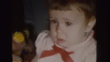 Nebraska (1955): Child Sitting On The Floor And Person Stirring Supposed Birthday
