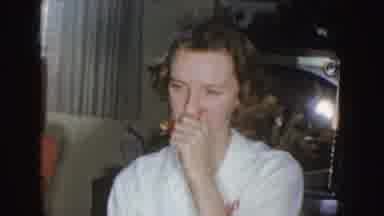 Nebraska (1955): Woman In White Holding Her Nose And A Cute Infant With A Red