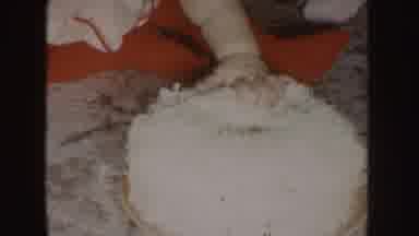 Nebraska (1955): Young Child Red White Holiday Outfit Puts Hand In White Cake