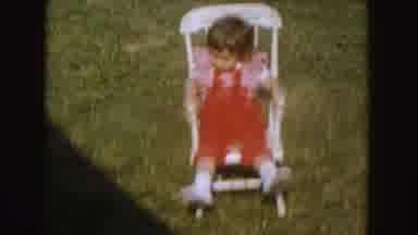 Nebraska (1955): Little Girl In A Red Jumper Trying To Rock Her Rocking Chair