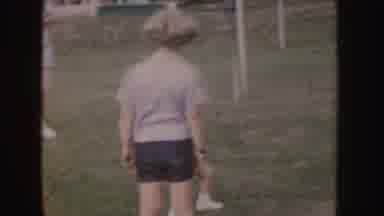 Nebraska (1955): People And Children Watching Baby In Red Clothes Walk On The Lawn