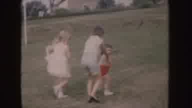 Nebraska (1955): Three Kids Playing On Green Grass On A Clear Day