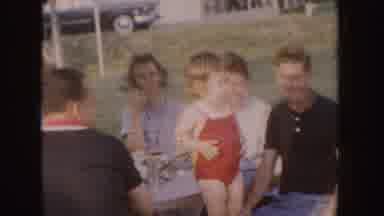 Nebraska (1955): A Little Girl In A Red Swimming Suit Stands On The Bench Of A