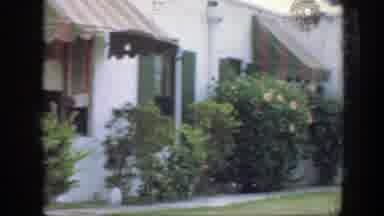 Florida-1945: Green Landscape Of A Backyard A House That Has White Siding And