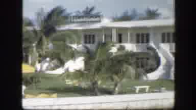 Florida (1945): View Of A White House With Green Palm Trees On A Bright Sunny Day