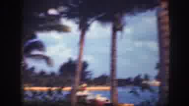 Florida (1945): Child Rubs Her Eyes While Walking On The Grass Near A Tropical
