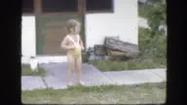 Florida (1945): A Little Girl Wearing A Yellow One-Piece Bathing Suit Stands On A
