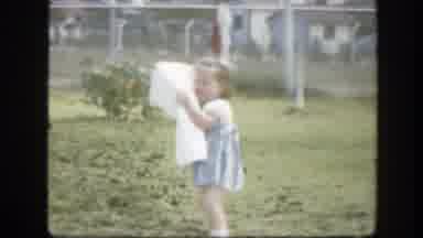 Florida (1945): A Little Girl Carries A Sheet Too Big For Her Arms
