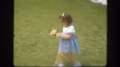 Florida (1945): A Little Girl In A Dress And Holding A Flower Walks Across A