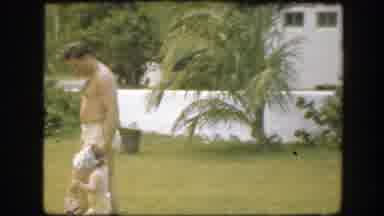 FLORIDA-1945: Man Walking With A Child In Backyard