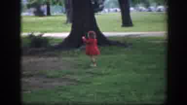 Washington DC (1945): Girl Wearing Red Coat Walks Towards Tree On A Clear Sunny