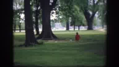 Washington DC (1945): Toddler Wearing Red Coat Chases Birds On Green Grass On A