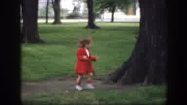 Washington DC (1945): Girl Wearing Red Coat Runs Past Tree On A Clear Day