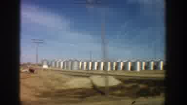 Aspen Colorado (1961): View Of Silver Storage Tanks In Tan Field On A Bright Sunny