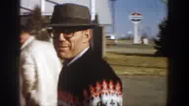 Aspen Colorado (1961): Man In A Hat And Glasses Talking And People Talking On The