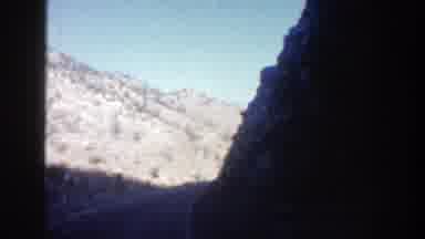 Aspen Colorado (1961): Approaching View Of Tan Mountains And Blue Sky On A Sunny