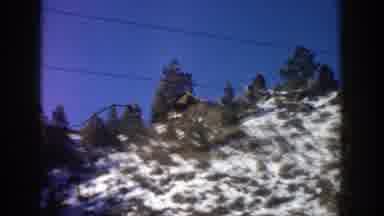 Aspen Colorado (1961): Passing View Of White Teepee On Side Of Road On A Sunny Day