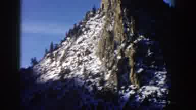 Aspen Colorado (1961): A Mountain Peak Dotted With Snow Followed By A Vehicle