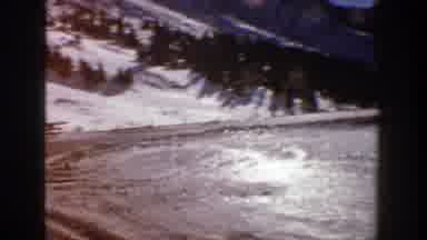 Aspen Colorado (1961): A Vehicle Travels Down An Icy Dirt Road In A Rural Area