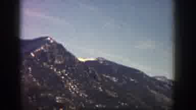 Aspen Colorado (1961): A Forest With Many Green Trees And Mountains Full Of Snow