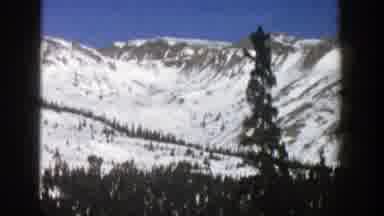 Aspen Colorado (1961): Mountains With Snow On Them And A City Sign Showing