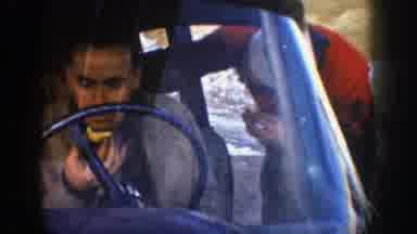 Aspen Colorado (1961): Four People Eating Yellow Objects Inside Of Blue Car On A