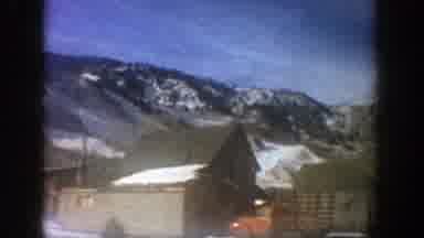 Aspen Colorado (1961): Homes Sit On The Side Of A Road At The Base Of Snow Covered