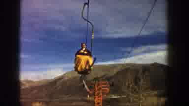 Aspen Colorado (1961): Man Takes Chairlift To The Top Of A Mountain At A Ski