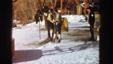 Aspen Colorado (1961): Man Assists Another Man Getting Onto Ski Lift Third Man