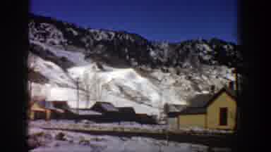 Aspen Colorado (1961): View Of Snow Covered Mountains And Yellow House On A Sunny
