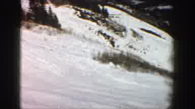 Aspen Colorado (1961): A Big Snow Mountain With Many Trees And Some People Skiing