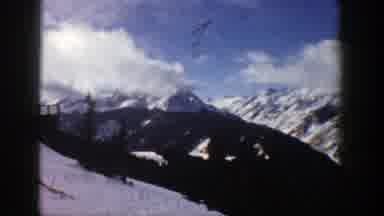 Aspen Colorado (1961): Panning View Of Snowy Mountains Extending Into The Cloudy