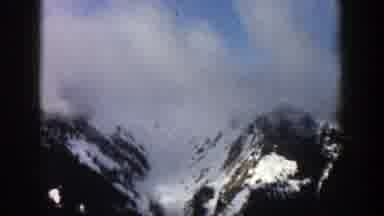 Aspen Colorado (1961): View Of Snow Covered Mountains Blue Sky And Clouds On A