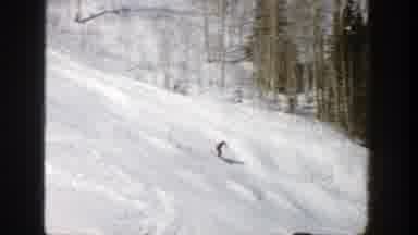 Aspen Colorado (1961): Man Wearing Yellow Sweater Watches Person Ski Downhill On A
