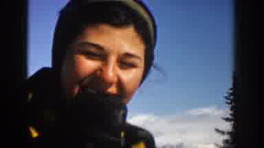 Aspen Colorado (1961): Woman Skiing On Snow-Covered Mountain Eating Snow
