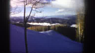 Aspen Colorado (1961): Snow Covered Wooded Hills Below Pale Blue Sky Lined With