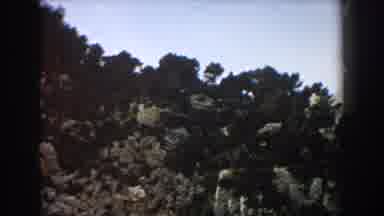 Italy (1960): View Of White Building On Tan Rocky Cliff With White Beach And Blue