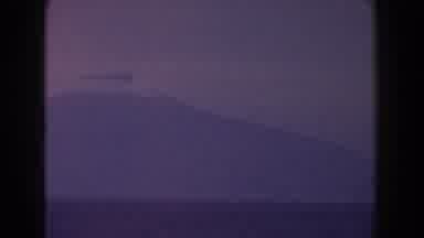 Italy (1960): View Of Ocean liner And Mountain Silhouette In A Hazy Day