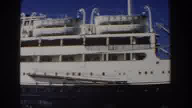 Italy (1960): Head To Tail Pan Shot Of A Small Docked Cruise Ship Port side