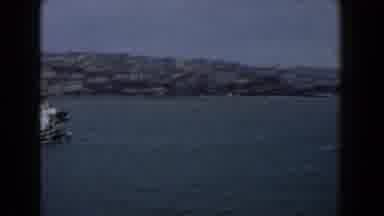 Italy (1960): A Boat Sailing Through The Channel Near A Dock While People Watch