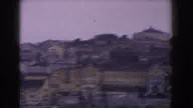 Italy (1960): A Sunny Day On A Boat Showing A Beautiful City On A Body Of Water