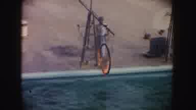California (1962): Dolphin Jumping Through A Fire Ring In A Pool With The Trainer