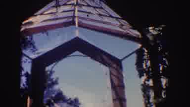 California (1962): People Leaving And Entering A Glass Structure Surrounded By